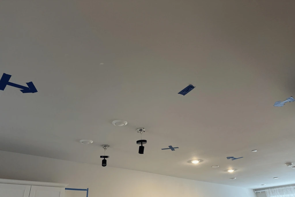 Ceiling marked with blue painter tape during restoration.